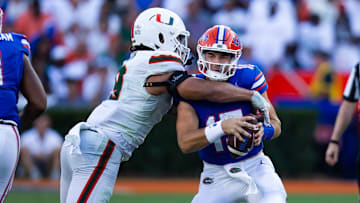 Miami Hurricanes defensive lineman Tyler Baron (9) sacks Florida Gators quarterback Graham Mertz (15) during the season opener at Ben Hill Griffin Stadium in Gainesville, FL on Saturday, August 31, 2024 against the University of Miami Hurricanes in the second half. Miami defeated the Gators 41-17. [Doug Engle/Gainesville Sun]