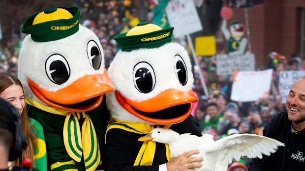 Lee Corso holds a duck alongside The Duck after picking the Ducks as the winner of Saturday   s top-10 matchup against the UC