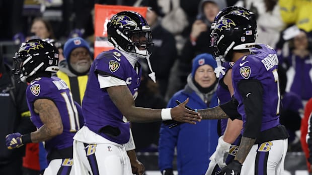 Baltimore Ravens quarterback Lamar Jackson (8) celebrates with Ravens wide receiver Rashod Bateman