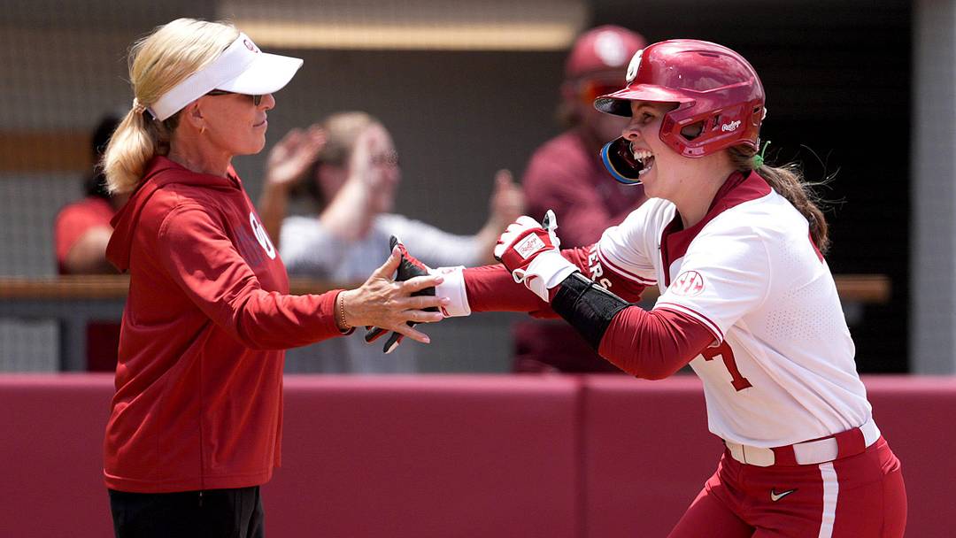Oklahoma's Kasidi Pickering (7) celebrates a home run with head coach Patty Gasso in the third inning during Game 1 of the NCAA Norman Super Regional softball game between the Mississippi State Bulldogs and the University of Oklahoma Sooners at Love's Field in Norman, Okla., May, 22, 2026. Mississippi State won 11-9.