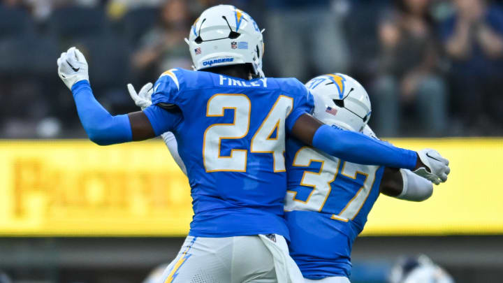 Aug 10, 2024; Inglewood, California, USA; Los Angeles Chargers safety Tony Jefferson (37) celebrates with safety AJ Finley (24) after scoring a touchdown against the Seattle Seahawks during the third quarter at SoFi Stadium. Mandatory Credit: Jonathan Hui-USA TODAY Sports