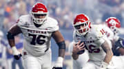 Dec 26, 2024; Phoenix, AZ, USA; Rutgers Scarlet Knights quarterback Athan Kaliakmanis (16) and offensive lineman Dantae Chin (76) against the Kansas State Wildcats during the Rate Bowl at Chase Field. Mandatory Credit: Mark J. Rebilas-Imagn Images