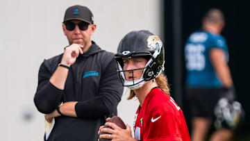 Jacksonville Jaguars quarterback Trevor Lawrence (16) falls back as Jacksonville Jaguars head coach Liam Coen watches during the Jacksonville Jaguars’ mandatory minicamp Tuesday June 10, 2025 at the Miller Electric Center in Jacksonville, Fla. 