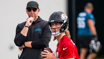 Jacksonville Jaguars quarterback Trevor Lawrence (16) falls back as Jacksonville Jaguars head coach Liam Coen watches during the Jacksonville Jaguars’ mandatory minicamp Tuesday June 10, 2025 at the Miller Electric Center in Jacksonville, Fla. [Doug Engle/Florida Times-Union]