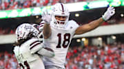 Mississippi State Bulldogs running back Davon Booth (21) celebrates after a touchdown with tight end Seydou Traore (18) against the Georgia Bulldogs in the third quarter at Sanford Stadium.