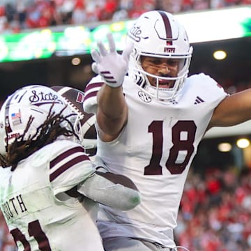 Mississippi State Bulldogs running back Davon Booth (21) celebrates after a touchdown with tight end Seydou Traore (18) against the Georgia Bulldogs in the third quarter at Sanford Stadium.