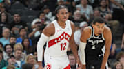 Oct 27, 2025; San Antonio, Texas, USA; Toronto Raptors forward Collin Murray-Boyles (12) and San Antonio Spurs forward/center Victor Wembanyama (1) look up the court in the second half at Frost Bank Center. Mandatory Credit: Daniel Dunn-Imagn Images