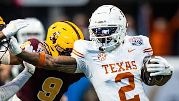 Texas Longhorns wide receiver Matthew Golden (2) grabs the facemark of Arizona State Sun Devils defensive back Myles Rowser (4) as he runs the ball in the first quarter as the Texas Longhorns play the Arizona State Sun Devils in the Peach Bowl College Football Playoff quarterfinal at Mercedes-Benz Stadium in Atlanta, Georgia, Jan. 1, 2025.