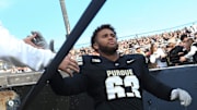 Purdue Boilermakers offensive lineman Marcus Mbow (63) high-fives a fan Saturday, Nov. 16, 2024, during the NCAA football game between the Purdue Boilermakers and the Penn State Nittany Lions at Ross-Ade Stadium in West Lafayette, Ind.