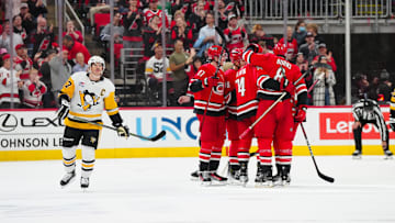 Nov 7, 2024; Raleigh, North Carolina, USA;  Carolina Hurricanes defenseman Jaccob Slavin (74) is congratulated by defenseman Brent Burns (8) and  right wing Andrei Svechnikov (37) after his goal against the Pittsburgh Penguins during the second period at Lenovo Center. Mandatory Credit: James Guillory-Imagn Images