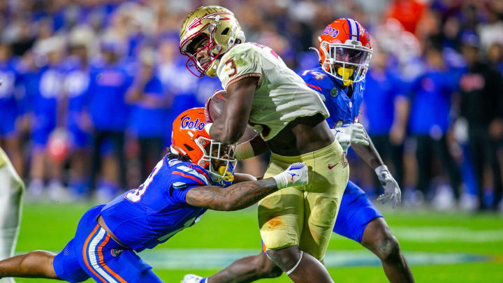 Florida State Seminoles running back Trey Benson (3) gets past Florida Gators safety Bryce Thornton (18) for a touchdown during second half action as Florida takes on Florida State at Steve Spurrier Field at Ben Hill Griffin Stadium in Gainesville, FL on Saturday, November 25, 2023. [Alan Youngblood/Gainesville Sun]