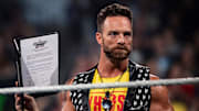 WWE Superstar L.A. Knight holds up his SummerSlam match contract against YouTube star Logan Paul.