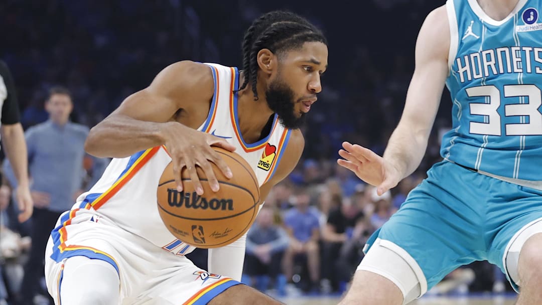 Oklahoma City Thunder guard Isaiah Joe (11) drives down the court beside Charlotte Hornets forward Liam McNeeley (33) during the second quarter of a game between the Charlotte Hornets and the Oklahoma City Thunder at Paycom Center.