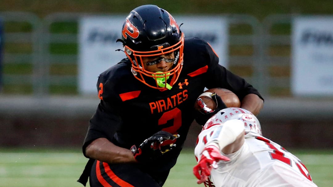 South Pittsburg's Dayon Cooper (2) carries the ball as McKenzie's Avery Brown (13) goes for a tackle during the 2025 TSSAA Class 1A Football State Championship game on Friday, Dec. 5, 2025, at Finley Stadium in Chattanooga.
