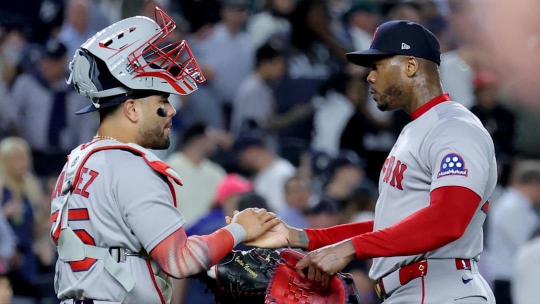 Sep 30, 2025; Bronx, New York, USA; Boston Red Sox catcher Carlos Narvaez (75) and relief pitcher Aroldis Chapman (44) celebrate after defeating the New York Yankees in game one of the Wildcard round of the 2025 MLB playoffs at Yankee Stadium. Mandatory Credit: Brad Penner-Imagn Images