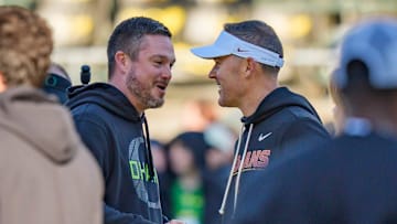 Oregon head coach Dan Lanning, left, and USC head coach Lincoln Riley shake hands before the game as the Oregon Ducks host the USC Trojans on Nov. 22, 2025, at Autzen Stadium in Eugene, Oregon.