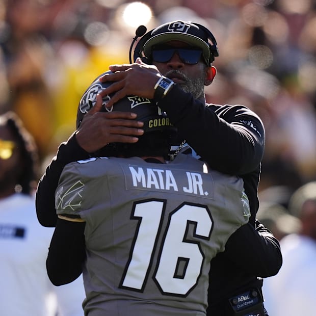 Nov 16, 2024; Boulder, Colorado, USA; Colorado Buffaloes head coach Deion Sanders hugs Colorado Buffaloes place kicker Alejan