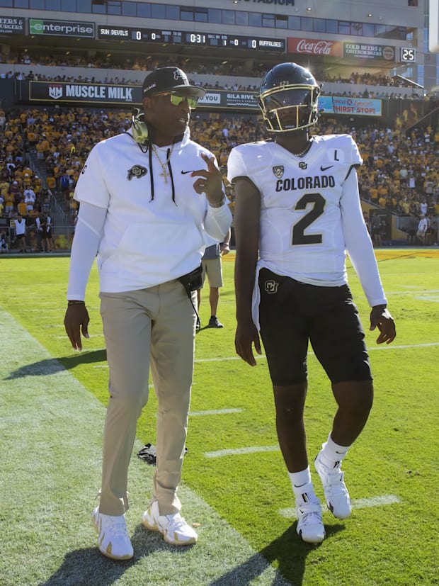 Oct 7, 2023; Tempe, Arizona, USA; Colorado Buffaloes head coach Deion Sanders with son and quarterback Shedeur Sanders (2) ag
