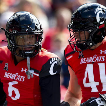 Oct 16, 2021; Cincinnati, Ohio, USA; Cincinnati Bearcats safety Bryan Cook (6) and Cincinnati Bearcats linebacker Joel Dublanko (41) celebrates after a third down stop in the first half of the NCAA football game between the Cincinnati Bearcats and the UCF Knights at Nippert Stadium. Mandatory Credit: Albert Cesare / The Enquirer-Imagn Images