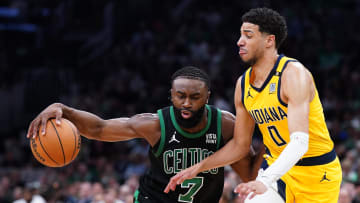 May 23, 2024; Boston, Massachusetts, USA; Boston Celtics guard Jaylen Brown (7) dribbles the ball against Indiana Pacers guard Tyrese Haliburton (0) in the first half during game two of the eastern conference finals for the 2024 NBA playoffs at TD Garden. Mandatory Credit: David Butler II-USA TODAY Sports