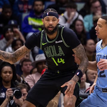 Dec 26, 2023; New Orleans, Louisiana, USA; New Orleans Pelicans forward Brandon Ingram (14) dribbles against Memphis Grizzlies guard Desmond Bane (22) during overtime at Smoothie King Center. Mandatory Credit: Stephen Lew-Imagn Images