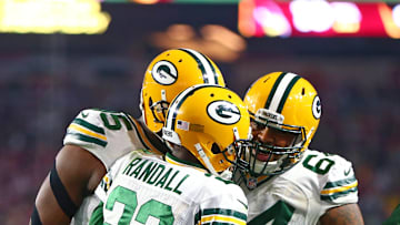 Jan 16, 2016; Glendale, AZ, USA; Green Bay Packers cornerback Damarious Randall (23) celebrates an interception with defensive tackle Mike Pennel (64) against the Arizona Cardinals during the NFC Divisional round playoff game at University of Phoenix Stadium. Mandatory Credit: Mark J. Rebilas-Imagn Images