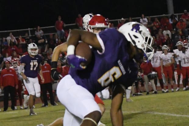 JT Lindsey (6) of Alexandria High School runs the ball against Ruston High School.