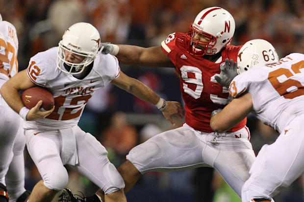 Texas  quarterback Colt McCoy tries to elude Nebraska's Ndamukong Suh during the 2009 Big 12 championship game