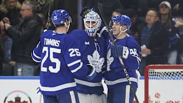 Nov 20, 2024; Toronto, Ontario, CAN; Toronto Maple Leafs defenseman Conor Timmins (25) and forward Alex Steeves congratulate goaltender Joseph Woll (60) on his shutout against the Vegas Golden Knights at Scotiabank Arena. Mandatory Credit: John E. Sokolowski-Imagn Images