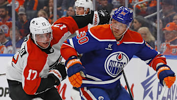 Oct 15, 2024; Edmonton, Alberta, CAN; Edmonton Oilers forward Corey Perry (90) and Philadelphia Flyers forward Jett Luchanko (17) chase a loose puck during the second period at Rogers Place.