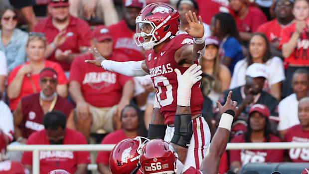 Arkansas quarterback Taylen Green is lifted high in the air in celebrates after scoring a touchdown against UAB.