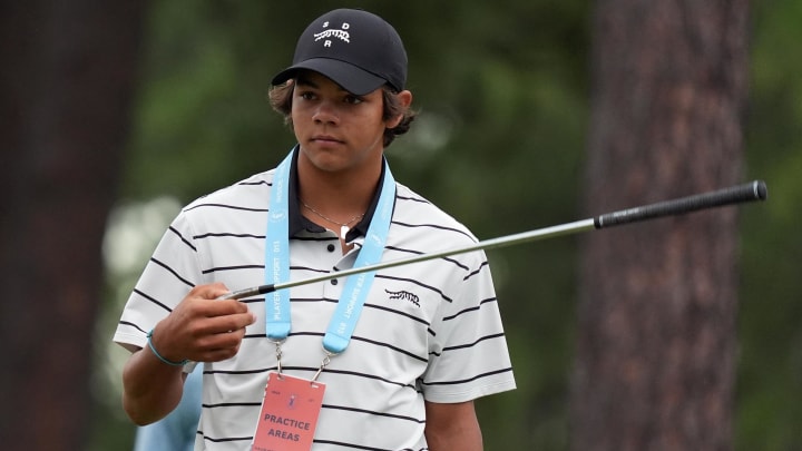 Jun 10, 2024; Pinehurst, North Carolina, USA; Charlie Woods walks up onto the 10th green during a practice round with his dad Tiger Woods for the U.S. Open golf tournament at Pinehurst No. 2. Mandatory Credit: Katie Goodale-USA TODAY Sports