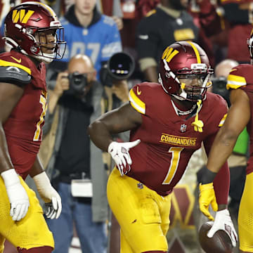 Nov 9, 2025; Landover, Maryland, USA; Washington Commanders wide receiver Robbie Chosen (12) celebrates with Commanders running back Jeremy McNichols (26) after catching a touchdown pass against the Detroit Lions in the third quarter at Northwest Stadium. Mandatory Credit: Geoff Burke-Imagn Images