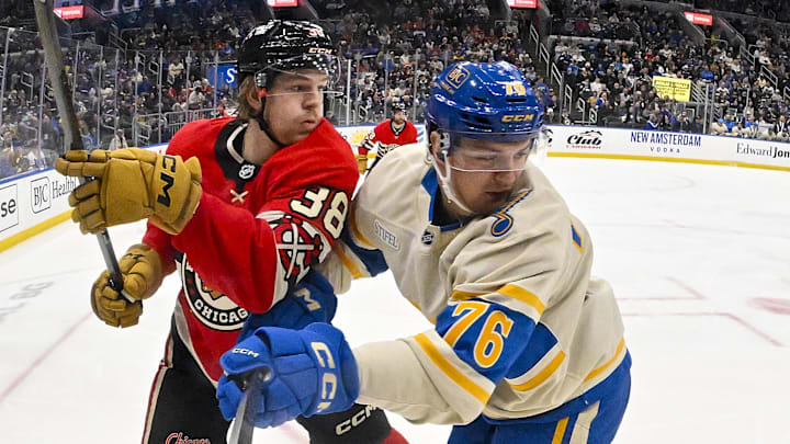 Feb 8, 2025; St. Louis, Missouri, USA;  St. Louis Blues center Zack Bolduc (76) skates against Chicago Blackhawks defenseman Ethan Del Mastro (38) during the second period at Enterprise Center. Mandatory Credit: Jeff Curry-Imagn Images
