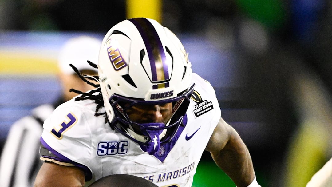 Dec 20, 2025; Eugene, OR, USA;  James Madison Dukes running back Wayne Knight (3) rushes as Oregon Ducks defensive back Aaron Flowers (21) defends during the second quarter at Autzen Stadium. Mandatory Credit: Troy Wayrynen-Imagn Images