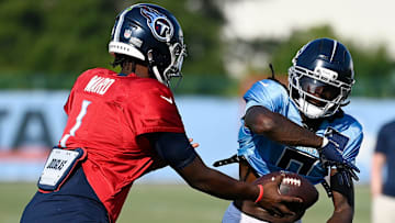 Tennessee Titans quarterback Cam Ward (1) hands the ball off to wide receiver Calvin Ridley (0) during an NFL football training camp practice at Ascension Saint Thomas Sports Park Saturday, Aug. 2, 2025, in Nashville, Tenn.