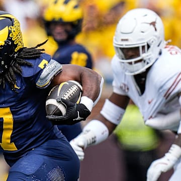 Michigan running back Donovan Edwards (7) runs for a first down against Texas during the first half at Michigan Stadium in Ann Arbor on Saturday, September 7, 2024.