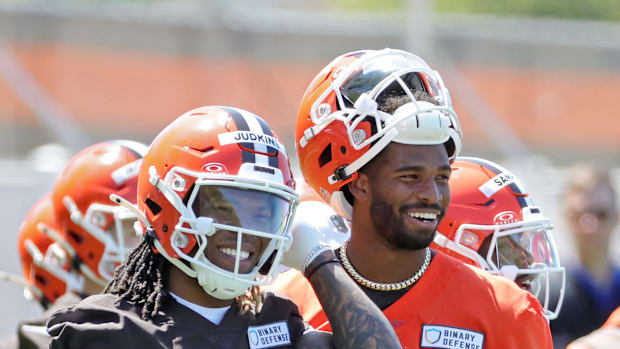 Cleveland Browns running back Quinshon Judkins (10) and quarterback Shedeur Sanders (12) share a laugh on the sideline during