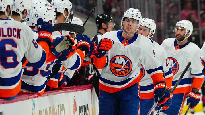 Apr 30, 2024; Raleigh, North Carolina, USA; New York Islanders defenseman Mike Reilly (2) is congratulated after his goal against the Carolina Hurricanes during the first period in game five of the first round of the 2024 Stanley Cup Playoffs at PNC Arena. Mandatory Credit: James Guillory-Imagn Images