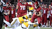 Nov 30, 2024; Pullman, Washington, USA; Wyoming Cowboys defensive end Tyce Westland (40) tackles Washington State Cougars quarterback John Mateer (10) in the first half at Gesa Field at Martin Stadium. Mandatory Credit: James Snook-Imagn Images