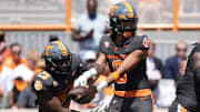 Tennessee quarterback Nico Iamaleava (8) hands the ball off to Tennessee running back Cameron Seldon (23) during a game between Tennessee and Chattanooga, Saturday, Aug. 31, 2024.