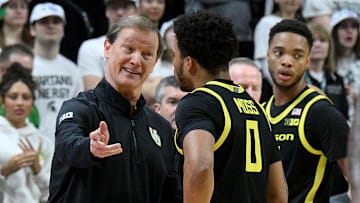 Feb 8, 2025; East Lansing, Michigan, USA;  Oregon Ducks head coach Dana Altman talks to Oregon Ducks guard Ra'Heim Moss (0) during the first half against the Michigan State Spartans at Jack Breslin Student Events Center. Mandatory Credit: Dale Young-Imagn Images
