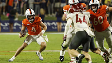 Oct 18, 2025; Charlottesville, Virginia, USA; Virginia Cavaliers quarterback Chandler Morris (4) runs with the ballas Washington State Cougars linebacker Parker McKenna (44) chases in the fourth quarter at Scott Stadium. Mandatory Credit: Geoff Burke-Imagn Images
