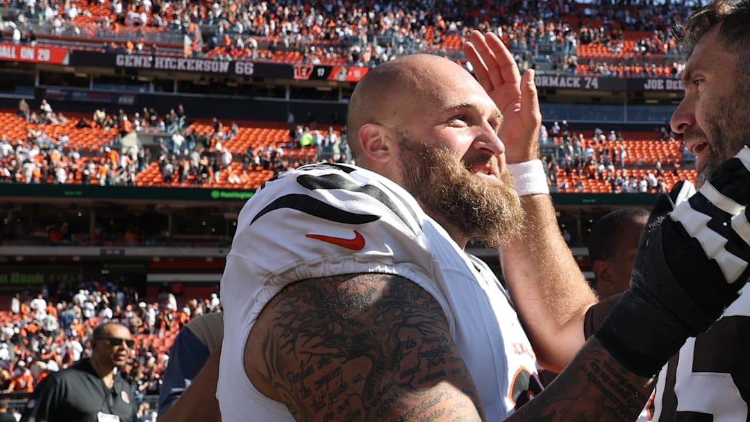 Sep 7, 2025; Cleveland, Ohio, USA; Cincinnati Bengals guard Dalton Risner (66) and Cleveland Browns quarterback Joe Flacco (15) greet each other after a game at Huntington Bank Field. Mandatory Credit: Scott Galvin-Imagn Images