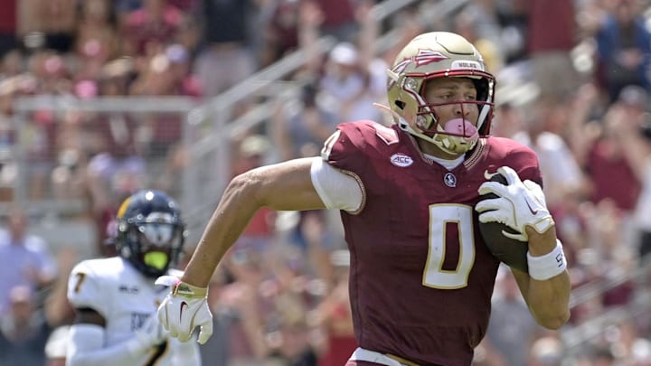 Sep 6, 2025; Tallahassee, Florida, USA; Florida State Seminoles wide receiver Duce Robinson (0) catches a touchdown during the first half against the East Texas A&M at Doak S. Campbell Stadium. Mandatory Credit: Melina Myers-Imagn Images