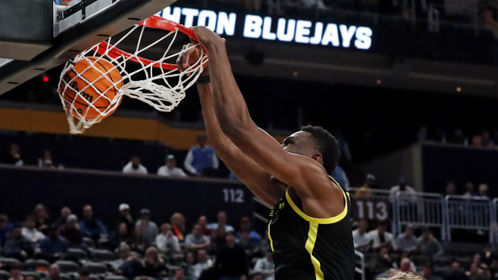 Mar 23, 2024; Pittsburgh, PA, USA; Oregon Ducks center N'Faly Dante (1) dunks the ball against Creighton Bluejays guard Baylor Scheierman (55) during the second half in the second round of the 2024 NCAA Tournament at PPG Paints Arena. Mandatory Credit: Charles LeClaire-USA TODAY Sports