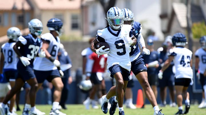 Dallas Cowboys receiver KaVontae Turpin runs with the ball after making a catch during training camp at River Ridge Fields