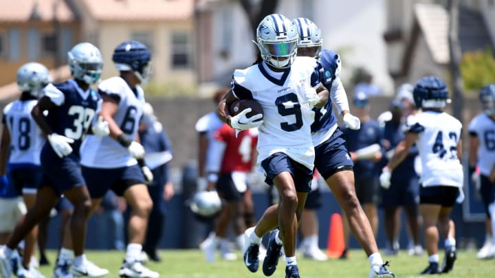 Cowboys receiver KaVontae Turpin runs with the ball after making a catch during training camp at River Ridge Fields in Oxnard on Saturday, 