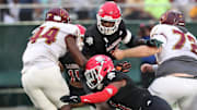 Savannah Christian's Jaden Miles and LaDamion Guyton look to stop New Hampstead's Kameron Blake-Mazes in the backfield