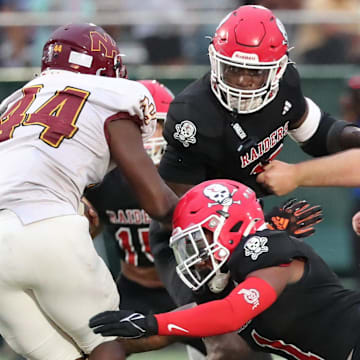 Savannah Christian's Jaden Miles and LaDamion Guyton look to stop New Hampstead's Kameron Blake-Mazes in the backfield